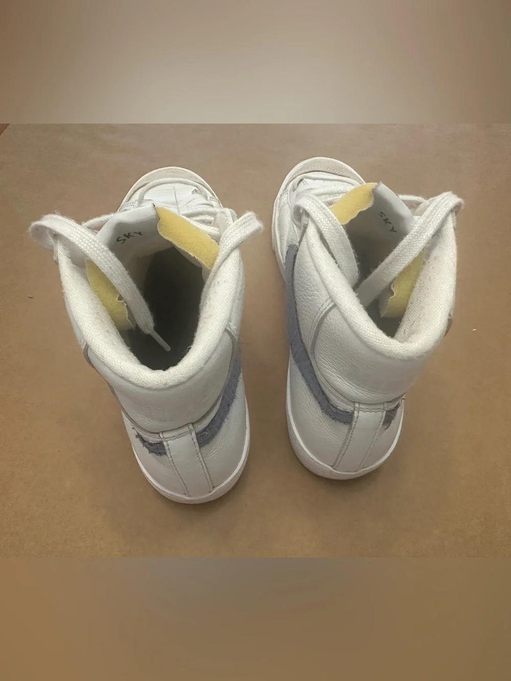 Nike White High-Top Sneakers with Blue Swoosh